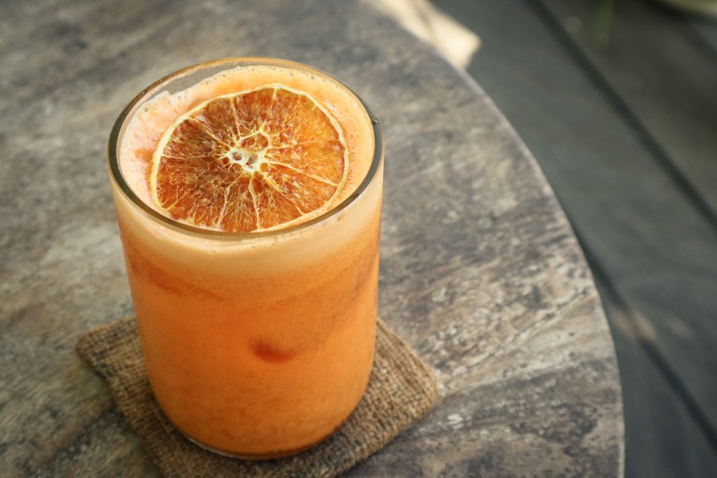 Orange,Cocktail,With,Orange,,Carrot,And,Papaya,Juice,In,Glass